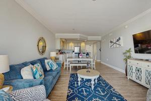a living room with a blue couch and a table at Belmont Towers 410 in Ocean City