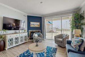 a living room with a couch and chairs and a fireplace at Belmont Towers 410 in Ocean City