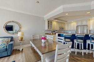 a kitchen and living room with a table and chairs at Belmont Towers 410 in Ocean City