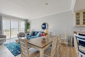 a living room with a table and a blue couch at Belmont Towers 410 in Ocean City