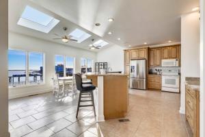 a large kitchen with a table and chairs and windows at Sunset Getaway in Ocean City