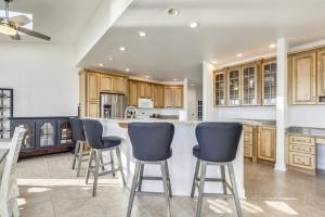a kitchen with wooden cabinets and blue bar stools at Sunset Getaway in Ocean City