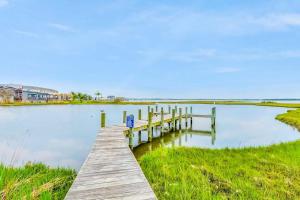 a dock on a body of water with a house at Sunset Bay III 313 in Ocean City