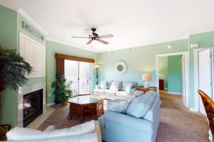 a living room with two couches and a fireplace at Sunset Bay III 313 in Ocean City