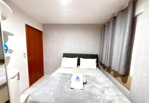 a bedroom with a bed with a book on it at Apartamentos Renovatio Jatiuca - Castelo B Temporada in Maceió +36 photos