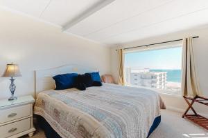 a bedroom with a bed and a large window at Excalibur 905 in Ocean City