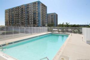 a large swimming pool with a tall building in the background at Excalibur 905 in Ocean City
