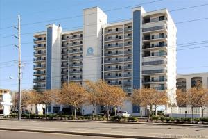 a large white building with trees in front of it at Excalibur 905 in Ocean City
