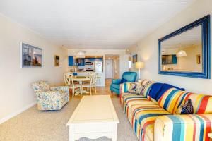 a living room with a couch and a table at Excalibur 905 in Ocean City