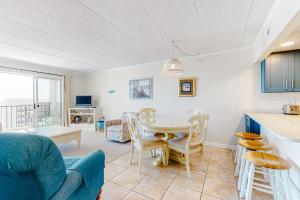 a kitchen and dining room with a table and chairs at Excalibur 905 in Ocean City +10 photos