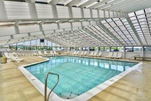 a large indoor swimming pool with a glass ceiling at Century I 2521 in Ocean City