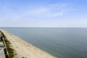 a beach with people on the sand and the water at Century I 2521 in Ocean City