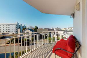 a red couch on the balcony of a building at Bahia Vista II 305 in Ocean City