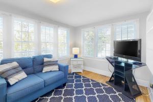 a living room with a blue couch and a flat screen tv at 900 Philadelphia in Ocean City +38 photos