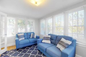 a living room with two blue couches and windows at 900 Philadelphia in Ocean City