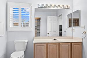 a bathroom with a sink and a toilet and a mirror at Waterfront Home with OC Skyline Views in Ocean City +53 photos
