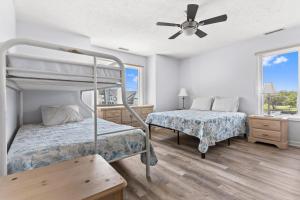a bedroom with two beds and a ceiling fan at Waterfront Home with OC Skyline Views in Ocean City