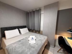 a hotel room with a bed with a towel on it at Apartamentos Renovatio Jatiuca - Castelo B Temporada in Maceió