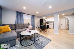 a living room with a couch and a table at Modern Urban Escape -King Bed -Pet Friendly - Free Parking & Netflix - Fast Wi-Fi in Edmonton +24 photos