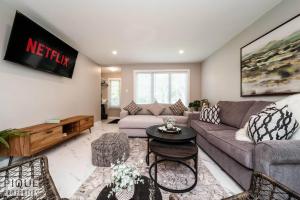 a living room with a couch and a table at Park Life Retreat - King Bed - Pet Friendly - Sleeps 6 in Edmonton