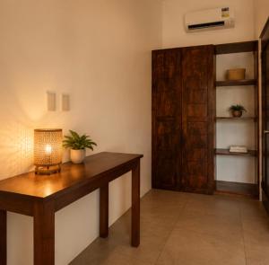 a room with a table with a lamp and a door at Anaiah Garden Resort in Moalboal