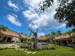 a resort with a palm tree in the yard at Anaiah Garden Resort in Moalboal