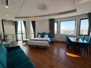 a bedroom with a bed and a desk and a table at Khách sạn VHL Hà Nam in Phủ Lý