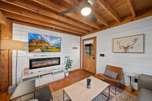 a living room with a tv on the wall at Fox Trail Cabin in Boone