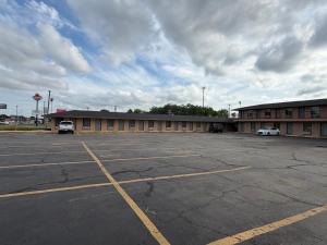 an empty parking lot in front of a building at Regency Inn in Muskogee