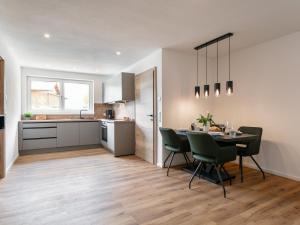 a kitchen and dining room with a table and chairs at Mosers Apartment in Reith im Alpbachtal