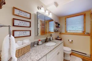 a bathroom with a sink and a toilet and a mirror at Gone Ski inn in West Dover +70 photos