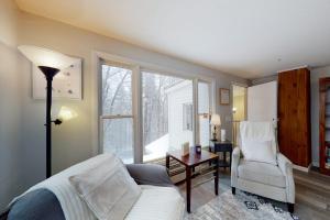 a bedroom with a bed and a chair and a window at Gone Ski inn in West Dover