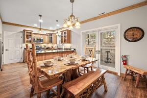 a kitchen and dining room with a wooden table and chairs at License to Chill Boone in Banner Elk