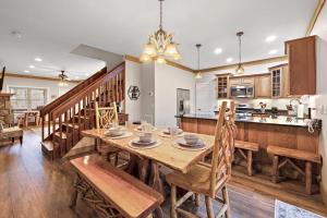 a dining room and kitchen with a wooden table and chairs at License to Chill Boone in Banner Elk +21 photos