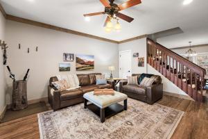 a living room with couches and a ceiling fan at License to Chill Boone in Banner Elk