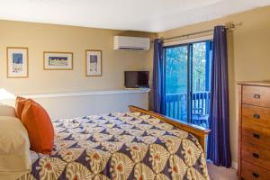 a bedroom with a bed and a window at Kingswood Vista 10F in White River Junction
