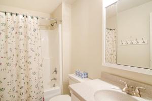 a bathroom with a sink and a shower curtain at Kingswood Vista 10F in White River Junction +28 photos