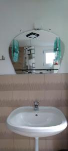 a white sink in a bathroom with a mirror at Villa sul lago in Jajce +57 photos