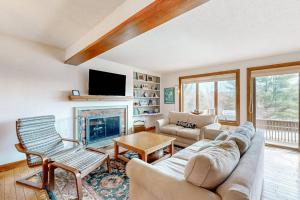 a living room with a couch and a fireplace at Saltbox 12B in White River Junction