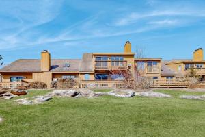 a large house with a large yard at Saltbox 12B in White River Junction