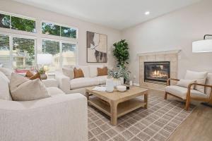 a living room with white furniture and a fireplace at Modern 3BR Davis Retreat in Davis