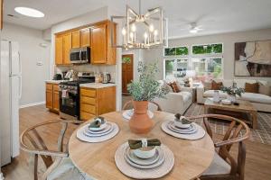 a kitchen and living room with a wooden table and chairs at Modern 3BR Davis Retreat in Davis