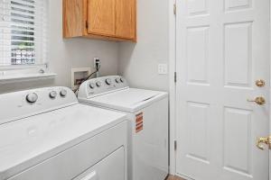 a white laundry room with a washer and dryer at Modern 3BR Davis Retreat in Davis +39 photos