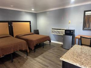 a hotel room with two beds and a table at Driftwood Motel in Colton