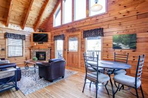 a living room with a table and chairs and a fireplace at Whisk-A-Way - Hot Tub, Pool Table & Jacuzzi! in Abbeyville