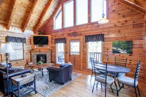 a living room with a fireplace and a table and chairs at Whisk-A-Way - Hot Tub, Pool Table & Jacuzzi! in Abbeyville
