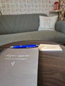 a pen sitting on top of a notebook on a table at Sogni appesi in Valleluce-Cese