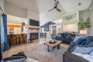 a living room with blue couches and a fireplace at Martinique in Redding