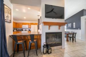 a kitchen with a fireplace with a tv on the wall at Martinique in Redding