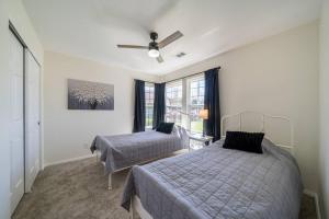 a bedroom with two beds and a ceiling fan at Martinique in Redding